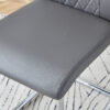 Table and chair set.71 * 35.4 inch rectangular dining table.Tempered Glass Tabletop,Silver 7-shaped Metal Table Legs.Paried With 8 Dark Gray High-quality PU Chairs With Arched Metal Legs.