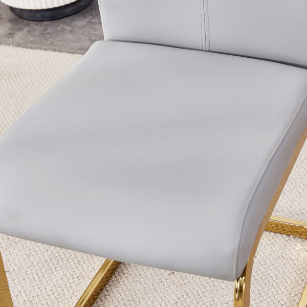 Table and chair set.71"x35.4"x30" Luxurious Pandora Patterned Glass Dining Tabletop with Golden Back To Back C-Shaped MDF Legs.Paried With 8 Light Gray PU Chairs with golden C-tube metal leg.