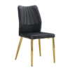 Four black dining chairs. A medieval modern chair made of PU material with soft cushions, equipped with golden metal legs. Suitable for restaurants and living rooms