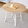 A modern and minimalist circular dining table with a 42 inch diameter wood colorer patterned tabletop and white metal legs. Suitable for restaurants, living rooms, and conference rooms.