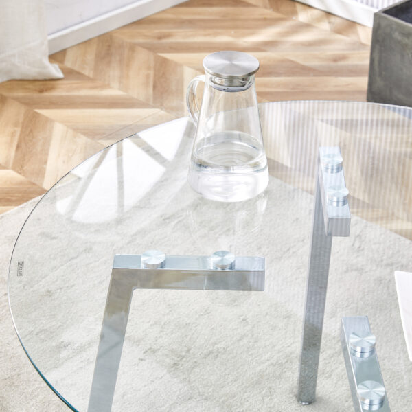 313792c3449f4ede813536dc9206d50d_a52846a6ae0e06b57b8578a2b5a20872 Table and chair set.Modern circular transparent tempered glass table, tempered glass tabletop, silver metal table legs.A Set of 4 White PU Comfort Dining Chairs with extended backrest.