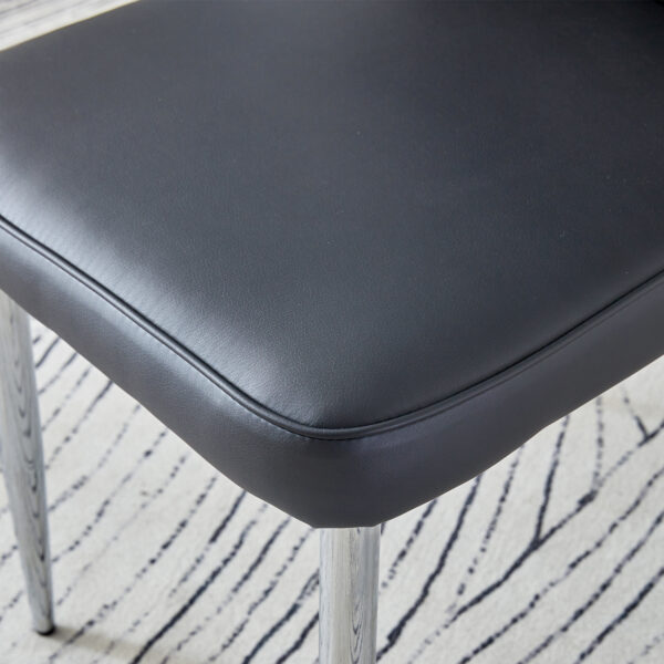 33617817d5ad4b5bb3b9653de182e5fb_ac3f938fdf6b84d0c68d35b99341c73a Table and chair set.63"x31.5x30" Black Marble-Patterned Slabs Tabletop with Stainless Steel Butterfly Legs.Paired with 4 Black PU dining chairs with a vertical stripe design on the backrest.