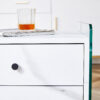 Double-drawer bedside table. The board surface is MDF sticker, and both sides are transparent tempered glass. The design is simple and elegant, with excellent storage functions.