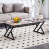 A coffee table is made of rock slab material, with a natural and smooth marble pattern on the surface, which complements the modern design of the black metal legs and adds a touch of fashion.47*23.6