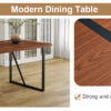 Table and chair set. A minimalist retro rectangular dining table with a specially textured top and black metal legs, paired with 6 soft chairs and black metal legs, showcases a beautiful home style.