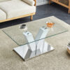 Modern minimalist coffee table. Transparent tempered glass tabletop with silver MDF pillars. Suitable for living room and dining room
