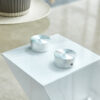 Modern minimalist coffee table. Transparent tempered glass tabletop with silver MDF pillars. Suitable for living room and dining room