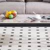A coffee table is made of rock slab material, with a natural and smooth marble pattern on the surface, which complements the modern design of the black metal legs and adds a touch of fashion.47*23.6