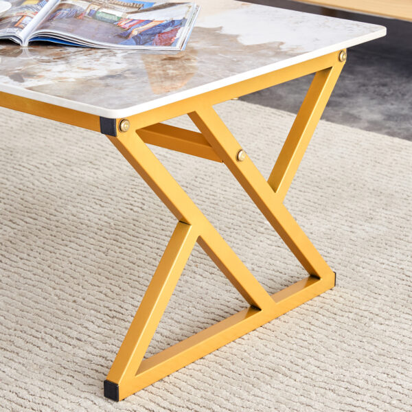 6ff44d22b3984c808d8d950b4dba6d00_ff63977193e551902482a8589616bddf A coffee table is made of rock slab material, with a natural and smooth marble pattern on the surface, which complements the modern design of the golden metal legs and adds a touch of fashion.47*23.6