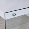 Table and chair set.White MDF Coffee Table - Reinforced with Tempered Glass Legs.Paired with 4 Dark Gray high-quality PU chairs with silver metal legs.