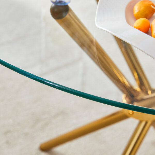 905652b23f0043ca94aeea82e43a6c1a_c7a963525536bd36b3bbe13554799556 Round clear glass dining table with a unique shape for 4-6 people, with ring-shaped gathered gold metal legs, suitable for desks, kitchens, terraces, dining rooms.
