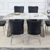 Table and chair set.63"x31.5x30" Luxurious Pandora patterned Sintered Stone Tabletop with Silver Stainless Steel Legs.Paried With 6 Black PU Chairs with a vertical stripe design on the backrest.