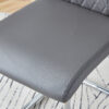 Table and chair set.63"x31.5x30" Luxurious Snow Mountain Patterned Sintered Stone Table with Silver Metal Butterfly Legs.Paried With 4 Dark Gray High-quality PU Chairs With Arched Metal Legs.