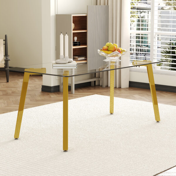 9b35836ce1d7451694157cac6e9bc579_11a528f8a898a38fb570634238e9c5c7 71 * 35.4 inch rectangular dining table. The transparent tempered glass tabletop is paired with golden 7-shaped metal table legs, showcasing a minimalist texture. Suitable for various places.