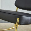 PU material cushioned rocking chair, unique rocking chair, cushioned seat, black backrest rocking chair, and gold metal legs. Comfortable side chairs in the living room, bedroom, and office