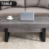 A rustic gray wood grain MDF coffee table with black metal legs - an elegant space in natural wood tones