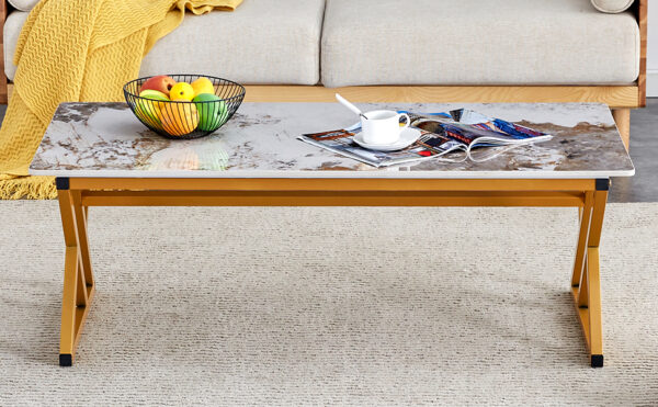 abe720930f6c4c159ec301823e78e0ec_ce6ec843417857bcba719c154747c796 A coffee table is made of rock slab material, with a natural and smooth marble pattern on the surface, which complements the modern design of the golden metal legs and adds a touch of fashion.47*23.6