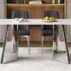 Table and chair set.63"x31.5x30" Luxurious Snow Mountain Patterned Sintered Stone Table with Silver Metal Butterfly Legs.Paired With 4 Black Chairs With Silver Metal Legs.Modern Light Luxury.