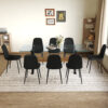 Table and chair set.79"x31.5" with X-shaped Black Metal Table Legs,Wood Grain Textured MDF Crossbeam.Paired With 8 Modern Mid-Century Style Upholstered Side Black PU Chairs.