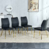 Four black dining chairs. A medieval modern chair made of PU material with soft cushions, equipped with golden metal legs. Suitable for restaurants and living rooms