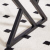 A coffee table is made of rock slab material, with a natural and smooth marble pattern on the surface, which complements the modern design of the black metal legs and adds a touch of fashion.47*23.6