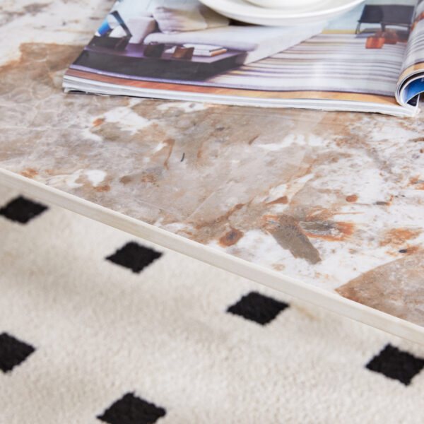 cf9d6568211341f0adf48368a49d9e29_95625aa495965ee1751baefd6fd1753b A coffee table is made of rock slab material, with a natural and smooth marble pattern on the surface, which complements the modern design of the black metal legs and adds a touch of fashion.47*23.6