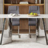 Table and chair set.63"x31.5x30" Luxurious Snow Mountain Patterned Sintered Stone Table with Silver Metal Butterfly Legs.Paried With 4 Dark Gray High-quality PU Chairs With Arched Metal Legs.
