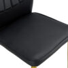 Four black dining chairs. A medieval modern chair made of PU material with soft cushions, equipped with golden metal legs. Suitable for restaurants and living rooms