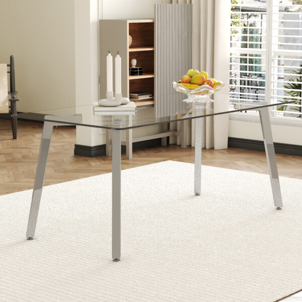 d44ef2ed7ac94c668731478bd16a07c7_5e3d16c1750b86da329b063c637e280c 71 * 35.4 inch rectangular dining table. The transparent tempered glass tabletop is paired with silver 7-shaped metal table legs, showcasing a minimalist texture. Suitable for various places.