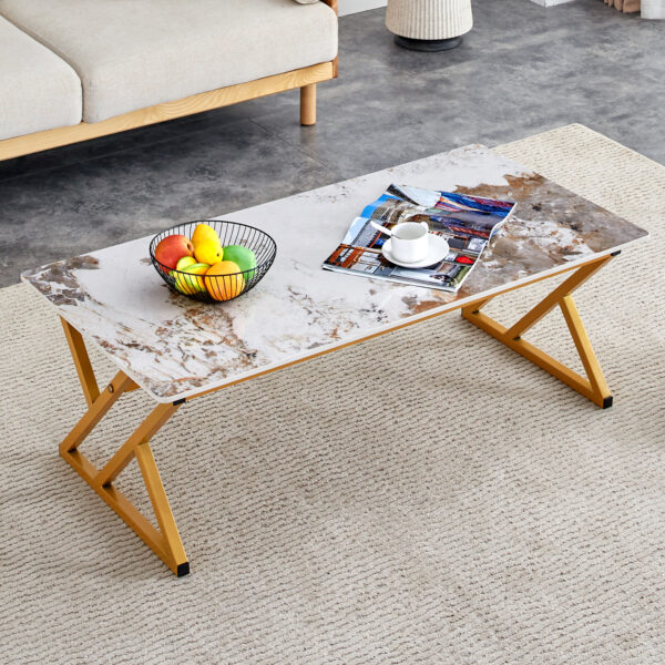 d566f4656b63452aaf9cc6b9481076c3_84b5e52a662ebb6debbb7a5893c6bef3 A coffee table is made of rock slab material, with a natural and smooth marble pattern on the surface, which complements the modern design of the golden metal legs and adds a touch of fashion.47*23.6