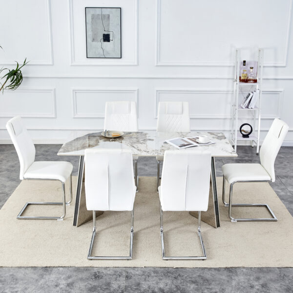 ed265f8a68074cb1978193bafbc60a1c_9d4811c4df49747961fae74fb61528d7 Table and chair set.63"x31.5x30" Luxurious Pandora patterned Sintered Stone Tabletop with Silver Stainless Steel Butterfly Legs.Paried With 6 White High-quality PU Chairs With Arched Metal Legs.
