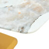 A modern minimalist dining table. Imitation marbled glass tabletop. Gold MDF table legs for kitchen and living room
