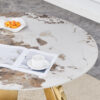 A 42-inch stainless steel white pattern burning stone round table with gold legs Round table suitable for 2, 4 or 6 people