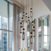 24" Modern Industrial Multi-Light Pendant Chandelier - 9-Light Black and Gold Adjustable Ceiling Light Fixture with Mesh Cylinder Shades for Living Room, Dining Room, or Staircase (Bulb Not Included)